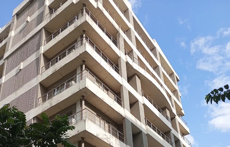 A hotel room balcony overlooking a scenic view, with comfortable seating and a small table, highlighting the private outdoor space.
