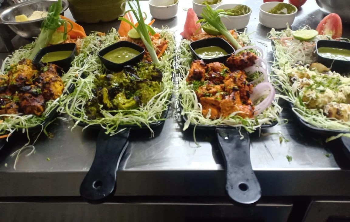 A beautifully set table with various dishes and a room service menu, showcasing the convenience of in-room dining.